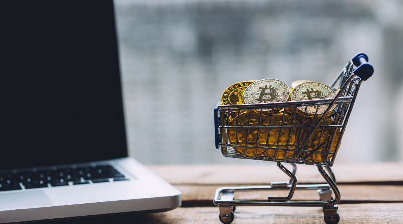 Laptop with shopping cart and cryptocurrency