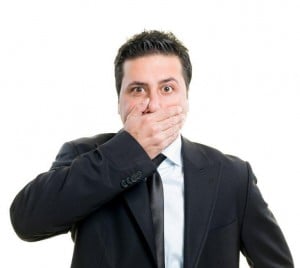 Man with hand on mouth - iStock photo