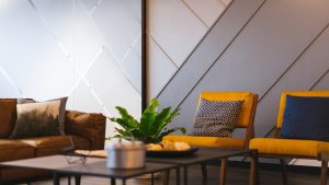 Hotel lobby with yellow chair and plant on coffee table
