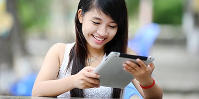 smiling woman on tablet