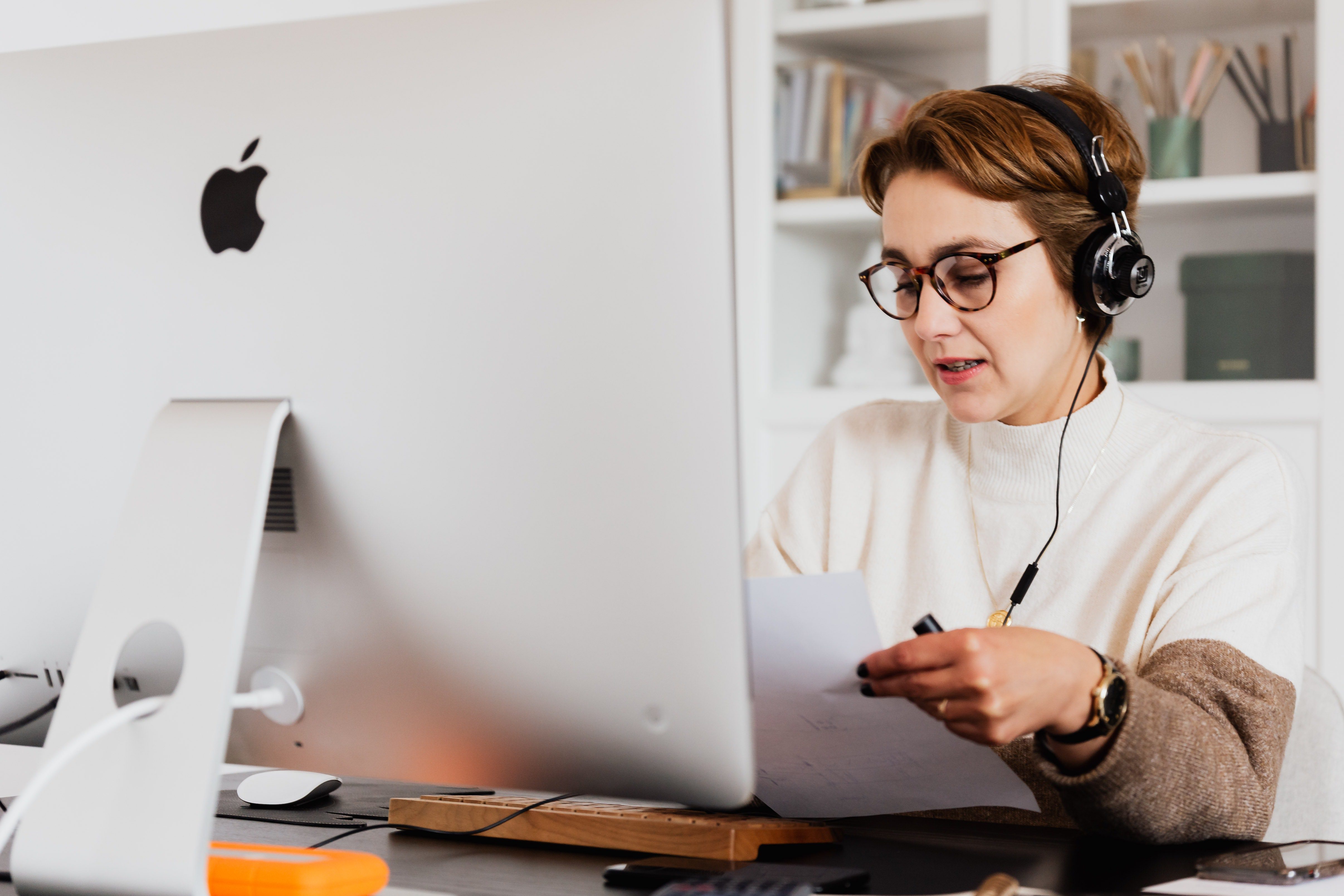 customer service representative at an apple desktop with headset on