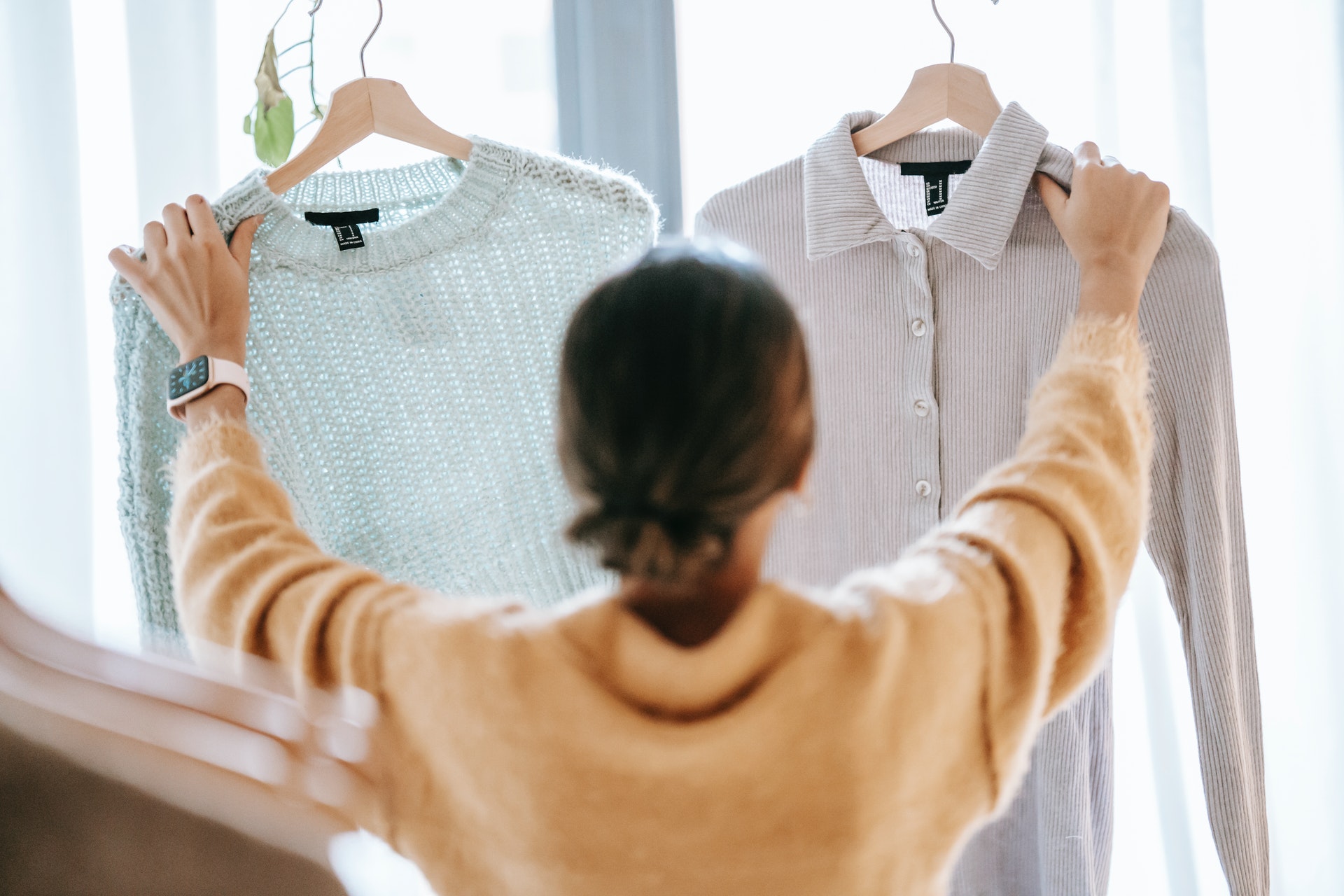 woman holding two shirts customer experience